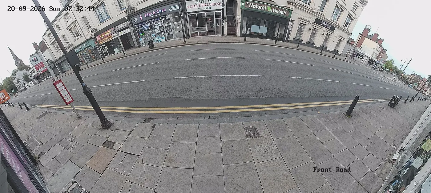 Live CCTV frame looking across Chapel Ash, Wolverhampton, at 7:32am — shopfronts, pavement and the A41 clearly visible